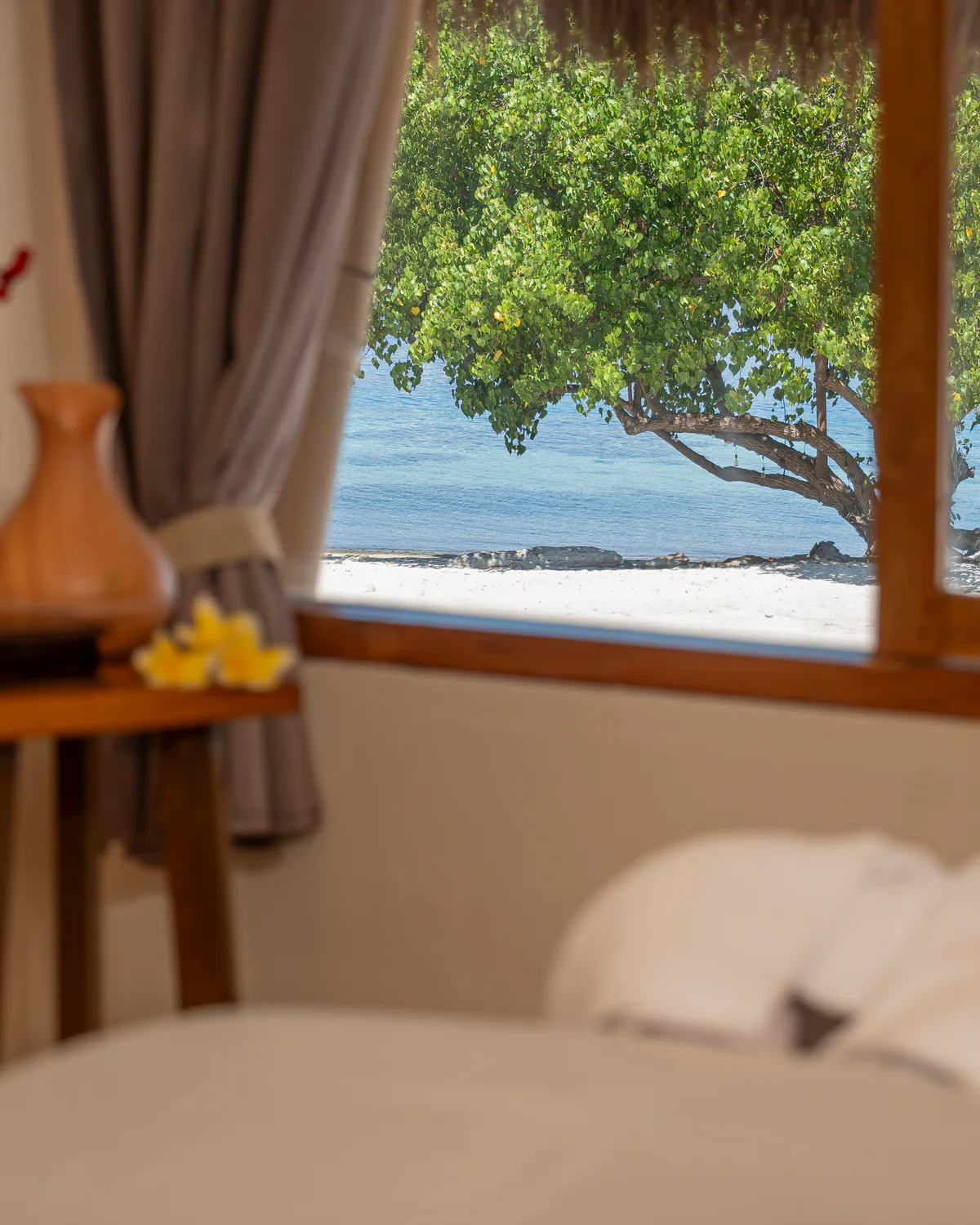 Massage table and frangipani at the Sebayur Spa, looking out to sea