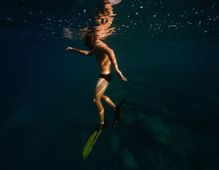 Snorkeler exploring vibrant coral reef in Komodo National Park